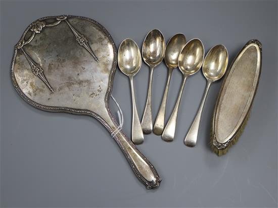 A set of four silver teaspoons, another teaspoon, a silver hand mirror mount and a silver-mounted brush
